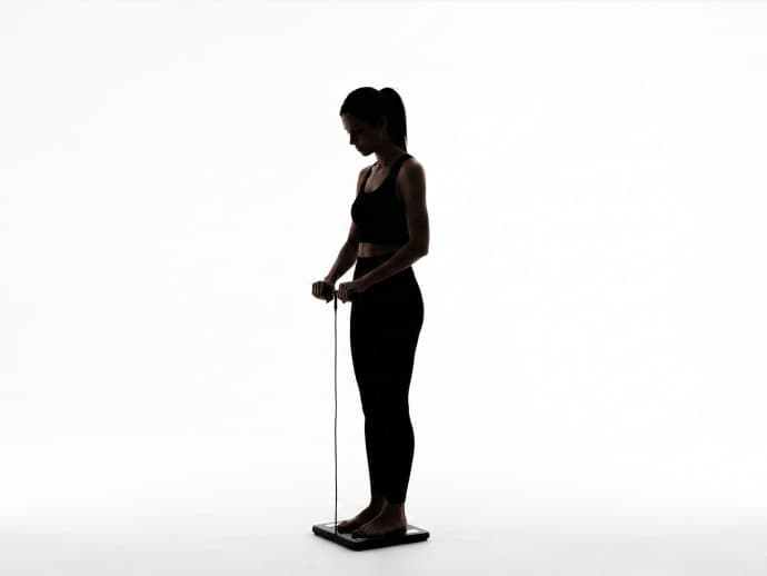 Person standing on a body composition scale